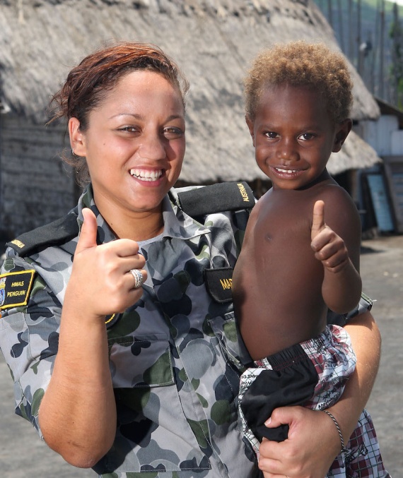 Seaman Writer Kim-Jade Martin from HMAS Tobruk meets a Papua New Guinean boy at a small coastal village in Rabaul during PACIFIC PARTNERSHIP 2010.