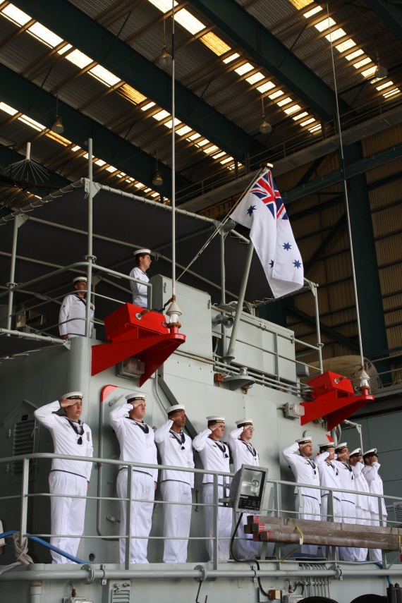 Ships Company of HMAS Wewak salute during the Decommissioning Ceremony at HMAS Cairns Naval Base, North Queensland.