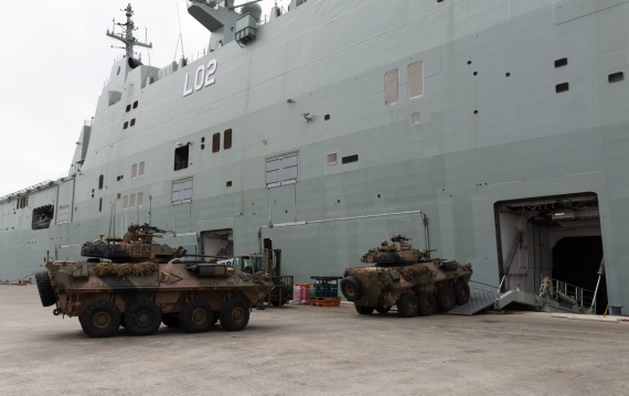 Australian Army soldiers from 2nd Cavalry Regiment drive ASLAVs (Australian Light-Armoured Vehicles) vehicles aboard HMAS Canberra in Townsville prior to a three-month deployment to Exercise RIMPAC 2016.