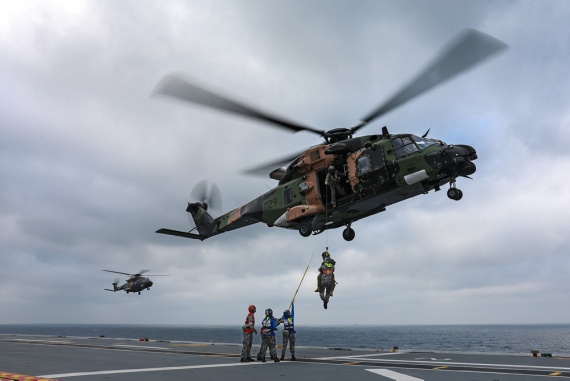 Aviation Support trainees practice winching operations with HMAS Adelaide's embarked MRH-90 helicopter, Poseidon 29.