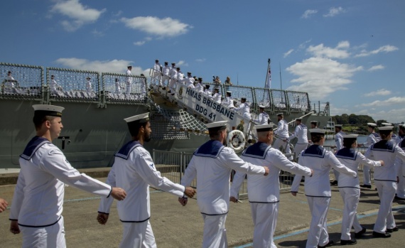 Members of the ship's company march on board during HMAS Brisbane's commissioning ceremony held at Garden Island, Sydney.