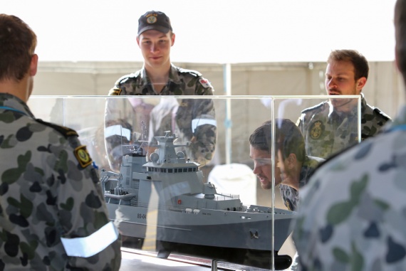 Royal Australian Navy sailors inspect a model of an Arafura class offshore patrol vessel at Osborne Naval Shipyard in Adelaide.