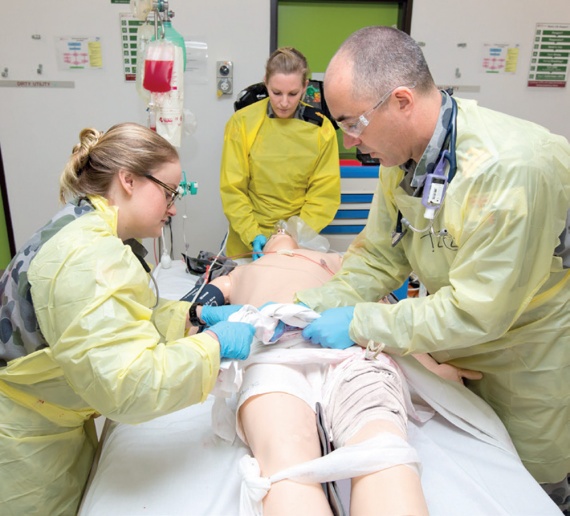 Members of the RAN Medical School conduct an initial assessment of a simulated casualty during a high fidelity medical simulation aimed to certify the RAN maritime operational health capabilities at the Unit Readiness level, at HMAS Penguin, Sydney.