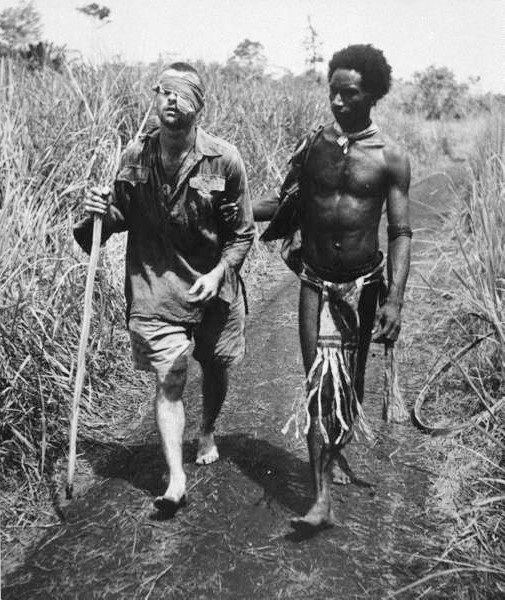 Papuan orderly Raphael Oimbari assists the wounded Private George ‘Dick’ Whittington at Buna on Christmas Day 1942