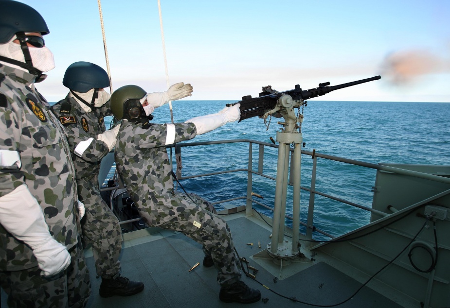 Leading Seaman Boatswains Mate Adam Yarnold (left), Seaman Boatswains Mate (SMNBM) Cory Pickett (right) and SMNBM Rhys Williams (middle) conduct a 12.7mm firing serial on board HMAS Bundaberg during Minor War Vessels Concentration Period.