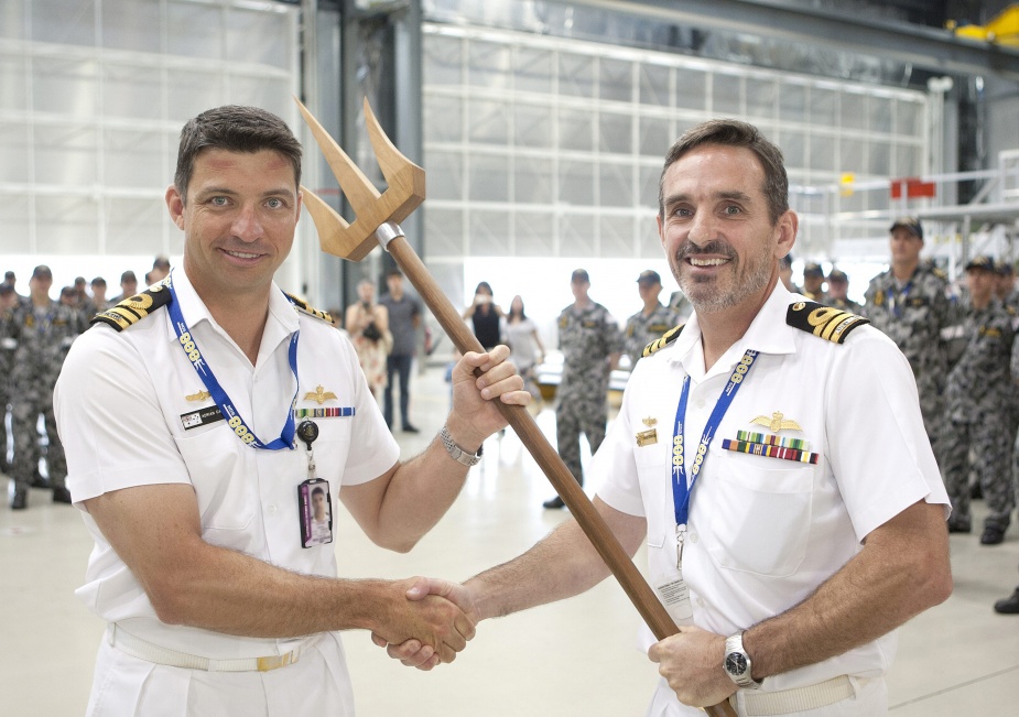 CO 808SQN CMDR Charlie Stephenson presents a ceremonial trident to CMDR Adrian Capner as a symbol of his assumption of command