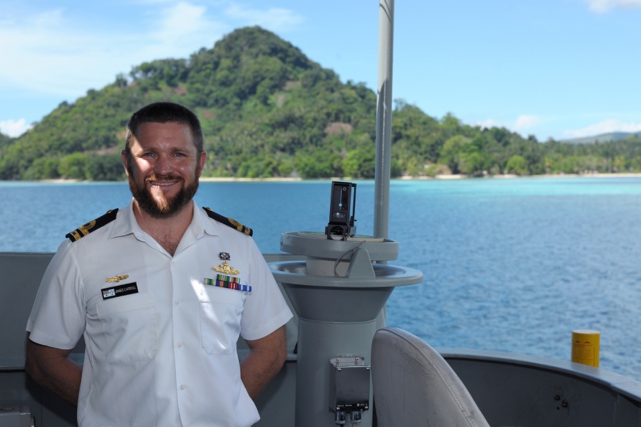 Commanding Officer HMAS Tarakan, Lieutenant James Carroll on the bridge wing of the Landing Craft Heavy off the Weather Coast, Solomon Islands, September 2014
