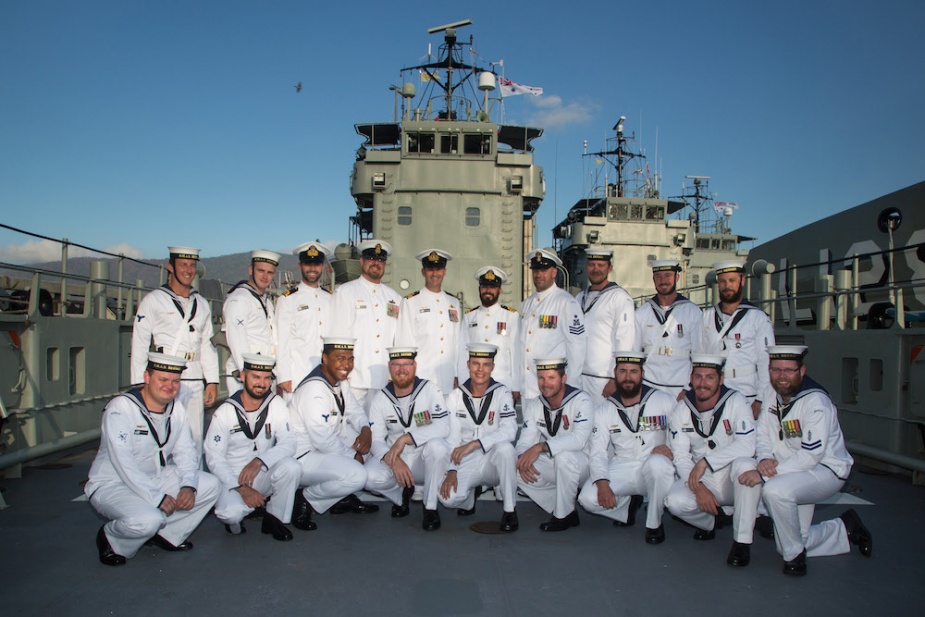 HMAS Brunei's decommissioning crew gathers on her tank deck for the final time.