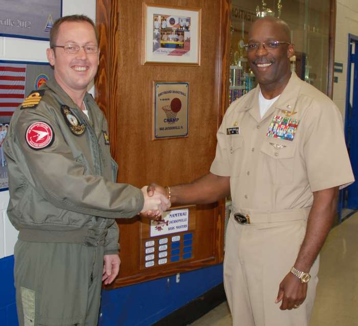 NUSQN 725 Commanding Officer, Commander David Frost, RAN, (left) is welcomed aboard the Center for Naval Aviation Technical Training Unit Jacksonville by Commanding Officer Commander Daryl Pierce, USN. Commander Pierce said it's an honor to work with a valued American ally from the Pacific Rim. (Photo courtesy Jax Air News)