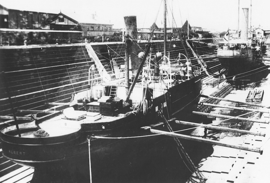 Albert in dock with Victoria visible in the background. Note that Albert has been stripped of her armament and fittings.