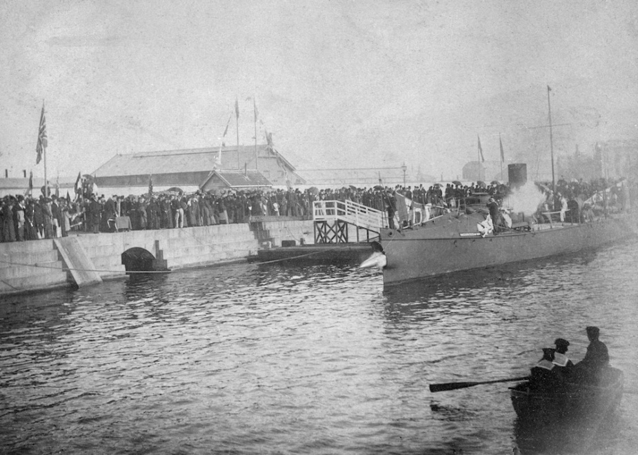 The christening of Countess of Hopetoun in the Alfred Dock, Williamstown, Victoria. Note the torpedo leaving its tube in the vessel's bow.