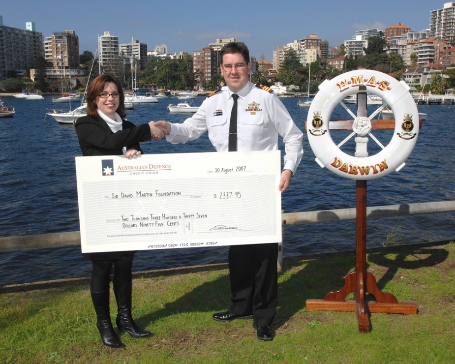 Commanding Officer HMAS Darwin, Commander Craig Powell presents a cheque to Janine Jackson, Foundation Manager of the Sir David Martin Foundation for $2337.25, 30 August 2007.
