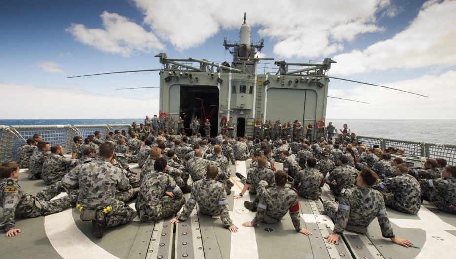 Ship's company of HMAS Darwin gather on the flight deck for a damage control exercise debrief provided by the damage control instructors, on the completion of a damage control exercise held onboard.