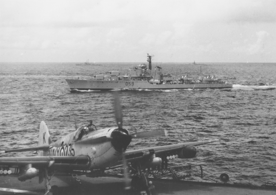 A Firefly on the deck HMAS Vengeance. HMAS Anzac is in the background.