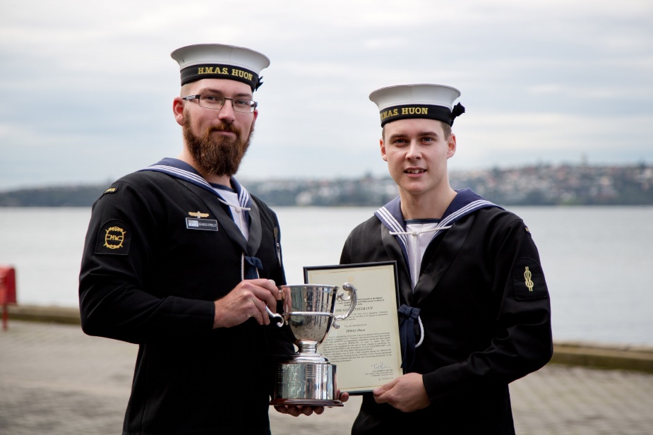 Able Seaman Seamus O'Reilly (left) and Able Seaman Cameron Johnson from HMAS Huon stand proudly with the Gloucester Cup after it had been presented to HMAS Huon by His Excellency General The Honourable Sir Peter Cosgrove AK, MC (Ret'd), Governor-General of the Commonwealth of Australia