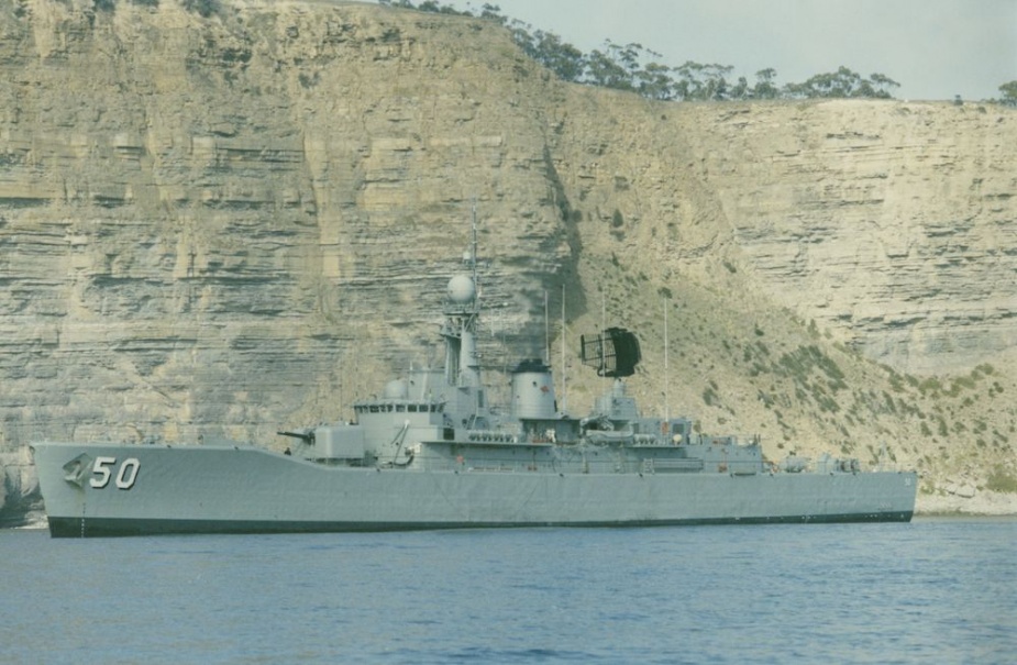 HMAS Swan seen beneath the towering cliffs of Fossil Bay, Maria Island off the south east coast of Tasmania. Photo: Lieutenant Evan Burton RAN