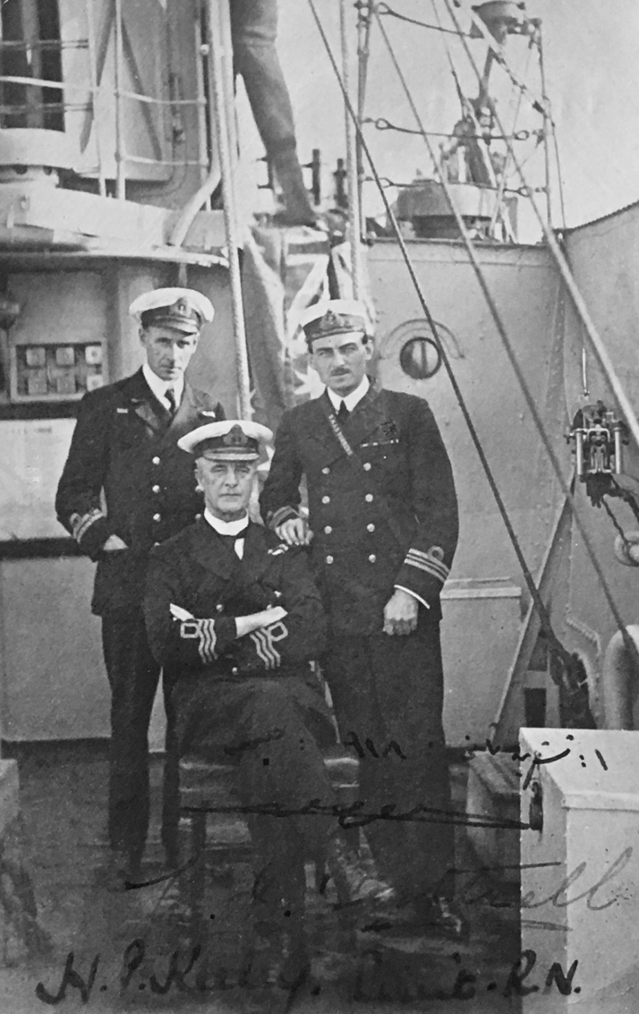 Lieutenant Harold Keeley, DSC, RN (Commanding Officer of HMAS Torrens), Commander William Cottrell, RNVR (seated) and Prince Tuvic Bey on board Torrens at the port of Cesme, Turkey on 1 November 1918 where the Turkish forces located in that port formally surrendered to the Allies.
