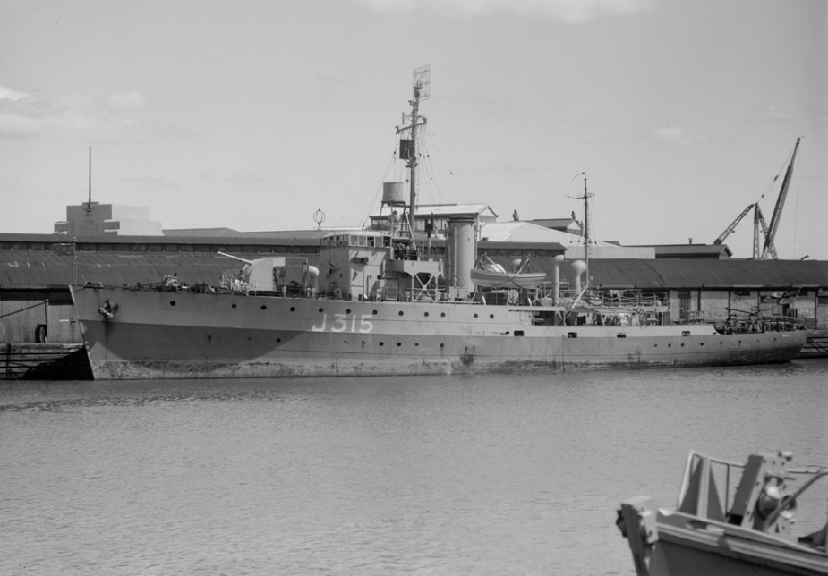 HMAS Wagga in Melbourne following her return to Australia in 1945. Note that she is riding high in the water, having been defuelled, as preparations are made to place her in Reserve status. (Allan C Green collection, State Library of Victoria)