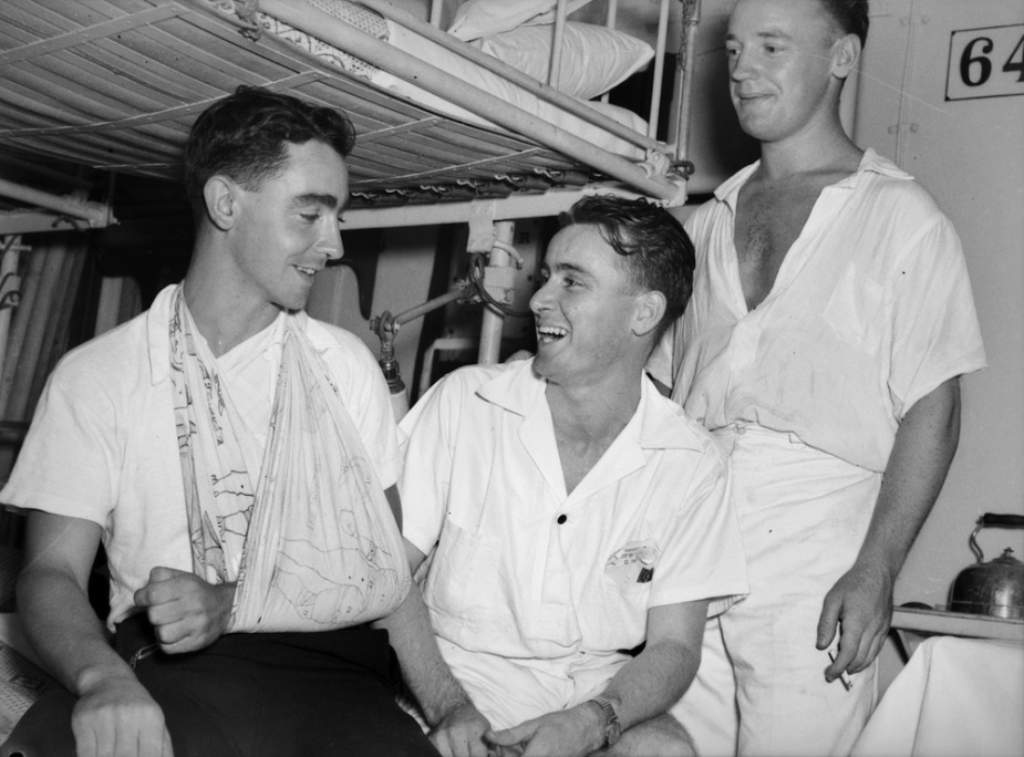 Sydney's only casualty following the action with the Bartolomeo Colleoni, Able Seaman D Thompson (left) with Leading Sick Berth Attendant C.J. Wilson and Sick Berth Attendant D.E. Shelley (AWM 002439).