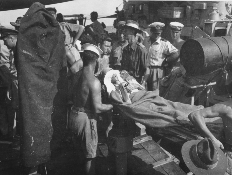 A stretcher case from Amboina being disembarked at Morotai from the Australian corvette HMAS Junee, September 1945.