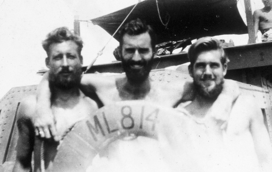 Three members of 814's crew pose with her life ring. L -R: R.Hayes. J. Nelson and D. Davey