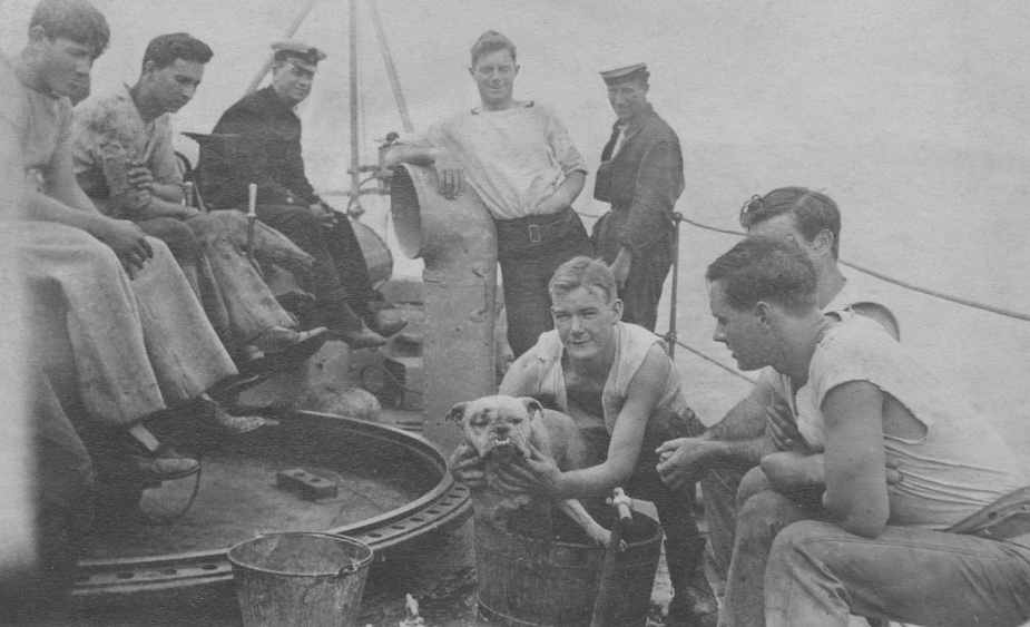 Members of HMAS Torrens crew with the ships mascot.