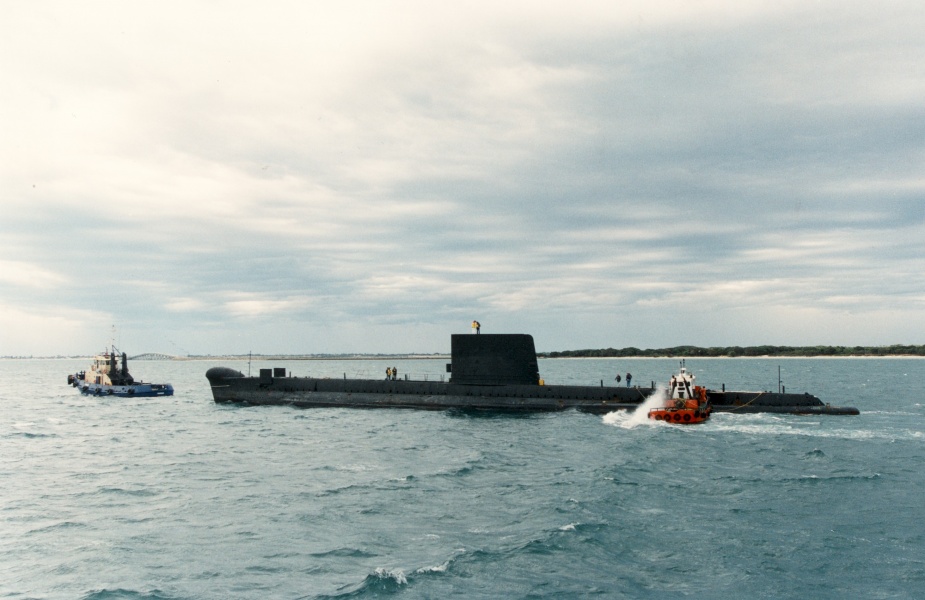 HMAS Ovens being towed away from HMAS Stirling after her decommissioning