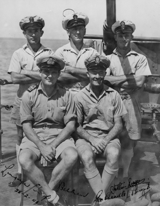 Informal group portrait of members of HMAS Shropshire. Identified, left to right, back row: Chief Petty Officer (CPO) Joe Feltham, DSM; CPO George Cheadle, DSM; Petty Officer Norbert 'Nutty' Ferris. Front row: Commander Warwick Bracegirdle, DSC and bar; CPO Arthur Cooper, DSM. (AWM P04749.001)