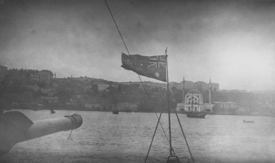 The Australian Flag flying from the bow of HMAS Parramatta on her arrival at Constantinople. The domed building in the background is the Dolmabahce Mosque.