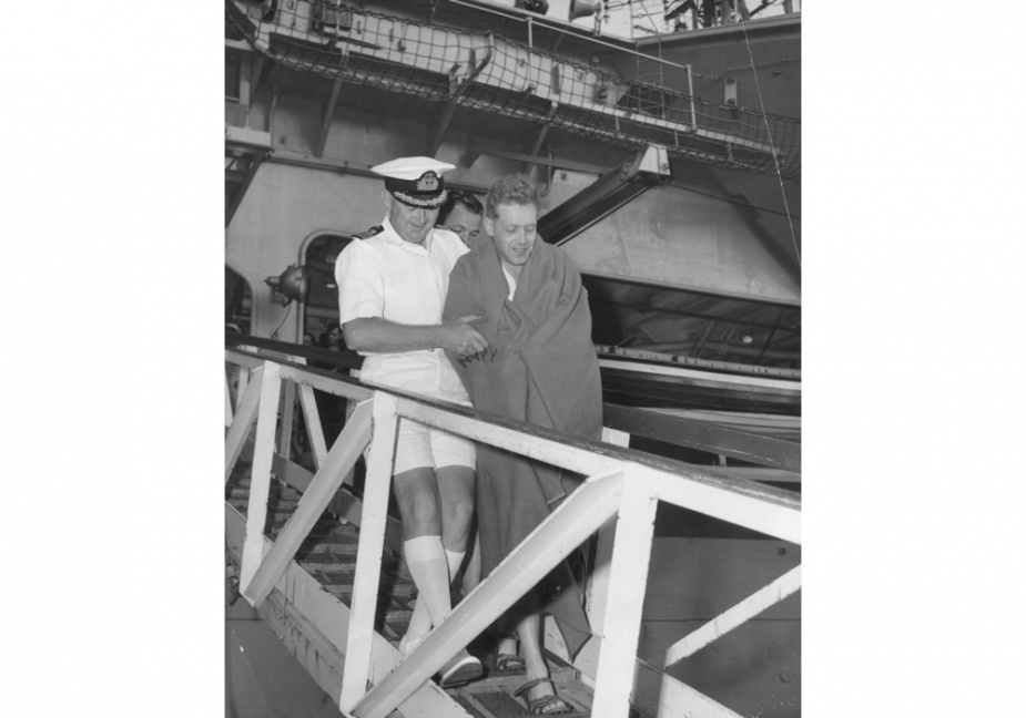 Surgeon Commander Brian Treloar, RAN and Lieutenant (Supply) CB Take, RN leaving the gangway of HMAS Melbourne in Sydney, circa February 1964.