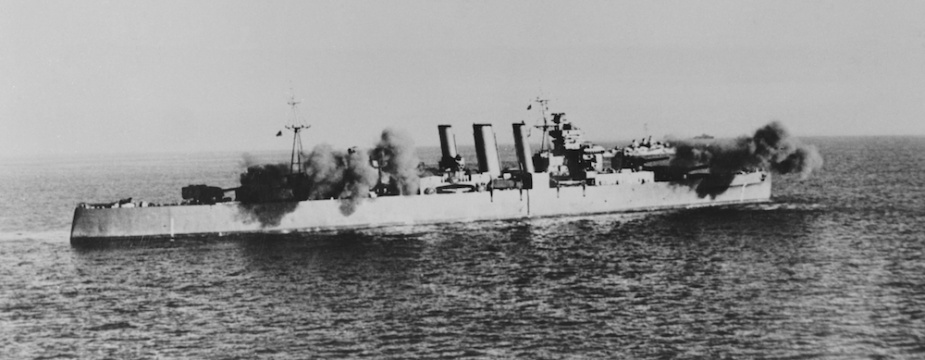 HMAS Shropshire carrying out a shore bombardment, circa 1944.