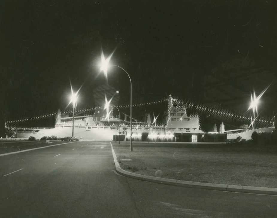 Stalwart illuminated with festoon lighting while along-side HMAS Stirling, 6 September 1980.