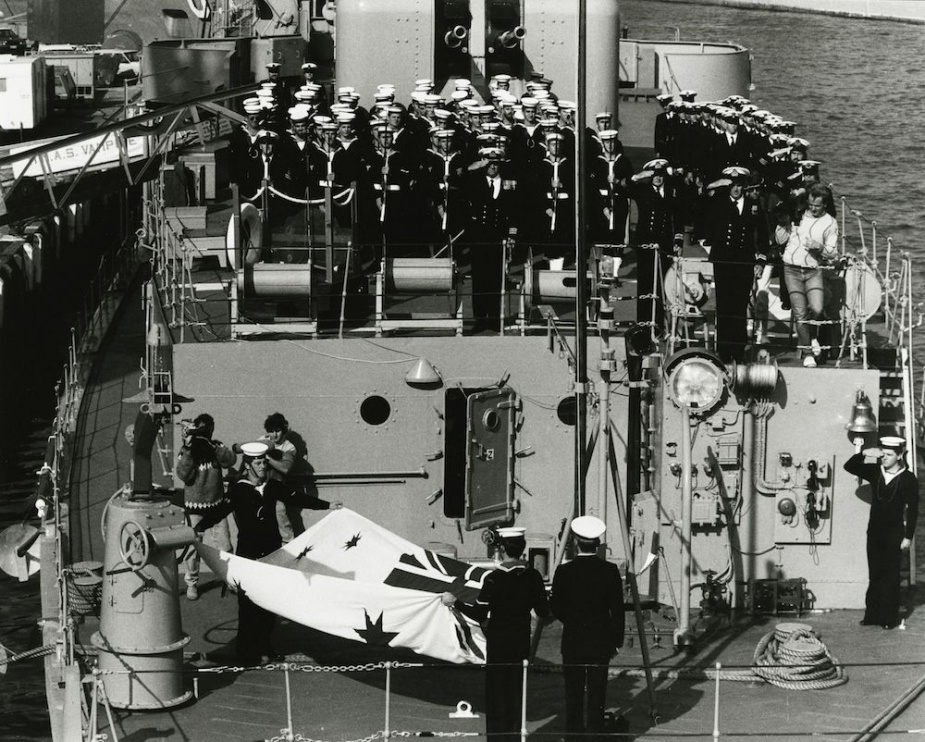 HMAS Vampire sailors bringing down her White Ensign for the last time prior to her decommissioning.