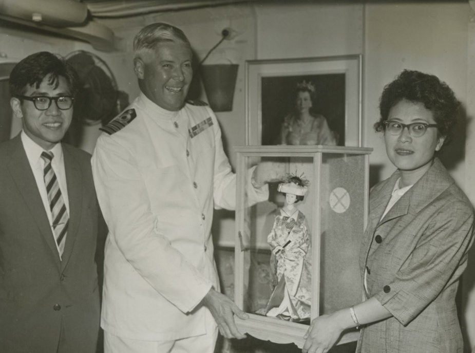 HMAS Vendetta's Commanding Officer Captain JM Ramsay, DSC, RAN is presented with a Japanese doll as a memento of the ship's visit to the port of Iwakuni.