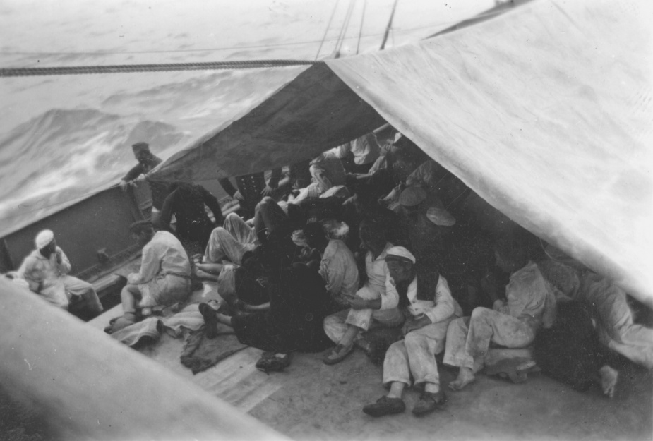 Kormoran ratings sheltering on the well-deck of HMAS Yandra following their rescue on 27 November 1941