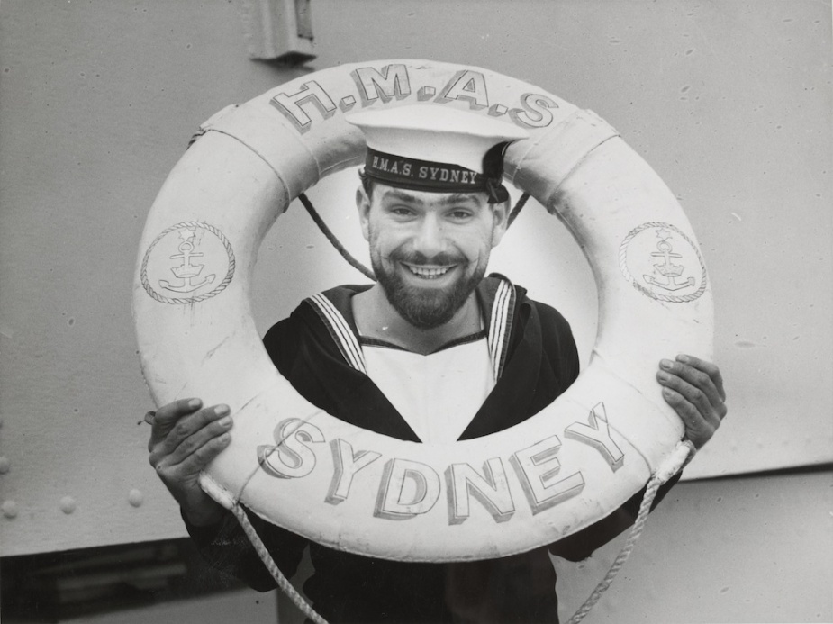 Able Seaman Jack Davenport poses with one of Sydney's ceremonial life rings prior to the outbreak of WWII (State Library of Victoria)