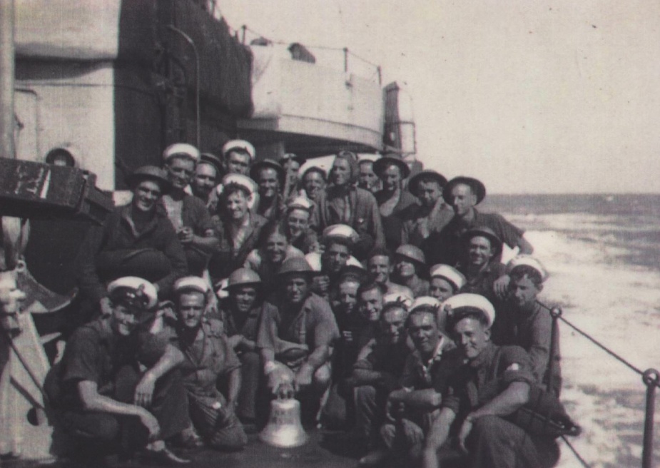Survivors from HMAS Nestor onboard HMS Javelin with their salvaged ship's bell.
