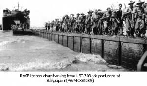 RAAF troops disembarking from LST703 via pontoons at Balikpapan (AWM OG3035)