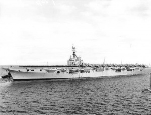 HMAS Sydney with the ship's company on deck and Fireflies and Sea Furies embarked.