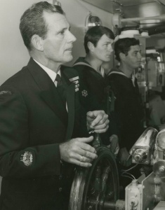 Warrant Officer Tim Collins, OAM, a well known RAN personality at the helm of Stalwart in 1983. With him are Leading Coxswain L Westbrook and Able Seaman Quartermaster Gunner P Gearing.
