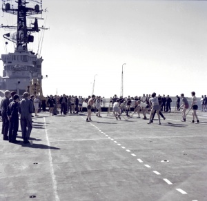 R&R aboard HMAS Melbourne; crew members playing deck hockey.