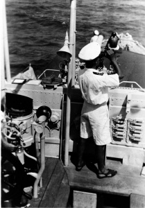 HMAS Yarra's Commanding Officer Lieutenant Commander WH Harrington closed up on the bridge in the Red Sea.