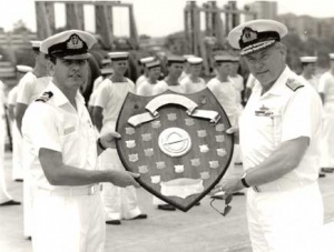 Rear Admiral R Walls, AO, RAN presenting Lieutenant Commander M Sander, RAN, Commanding Officer of Ovens, with the Submarine Fighting Efficiency Shield.