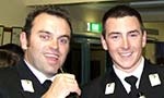 Two Midshipman relaxing at a social function.