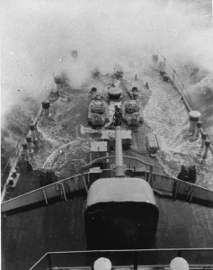 HMAS Adelaide takes water over the bow in 1939.