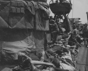 HMAS Vampire's decks crowded with Allied troops.