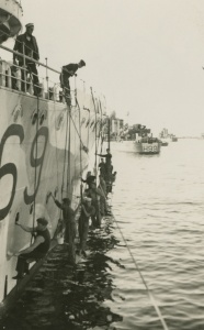 Vendetta's crew applying disruptive pattern camouflage to the ship's side c. April 1941