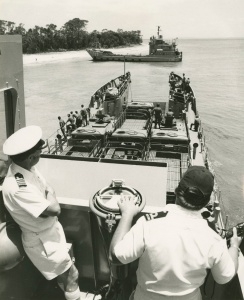 Captain WL Owen, RAN, Naval Officer in Charge Queensland observing beaching operations from Wewak in January 1981. HMAS Tarakan is visible in the background.