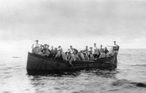 Crew of the German Supply Ship Coburg approaching HMAS Canberra (I) after scuttling their own ship to prevent it from being captured.