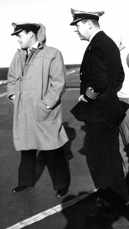 Captain Harries conferring with one of his officer"s onboard HMAS Sydney during her time in Korea.